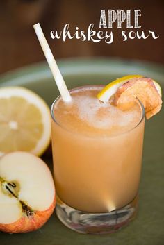 an apple whiskey sour cocktail is garnished with orange slices