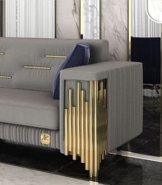 a grey couch with gold accents in a room