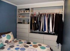 a bedroom with blue walls and white cabinets