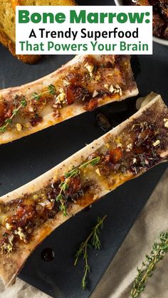 two slices of bone marrow sitting on top of a black plate