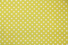 a yellow and white polka dot fabric with small white dots on the top of it