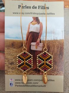 a pair of earrings is shown in front of a card with an advertise