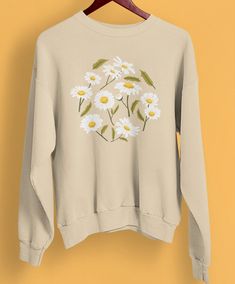 Introducing our exquisite Daisy Sweathirt, Wildflower Sweatshirt, and Boho Shirt - a delightful collection of floral sweatshirt designed to captivate hearts and celebrate the beauty of nature. This unisex sweatshirt is a perfect gift choice, adorned with Birth Month Flowers, making it an ideal present for your beloved sister or anyone special. Wildflower Sweatshirt, Daisy Sweatshirt, Wifey Sweatshirt, Floral Sweatshirt, Boho Shirt, Month Flowers, Sweat Shirts, Boho Shirts