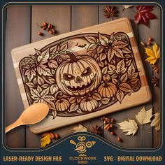 a wooden cutting board with an image of a pumpkin on it and leaves surrounding it