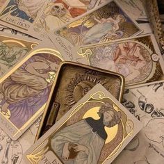 several tarot cards are laying on top of each other, all with different designs