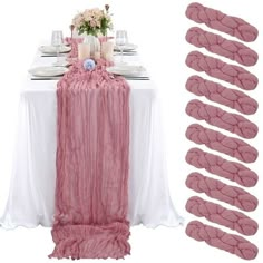 the table is set with pink linens and place settings