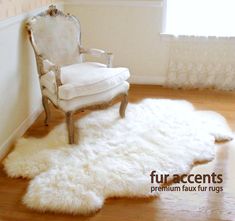 a white chair sitting on top of a hard wood floor next to a rug covered in sheepskin