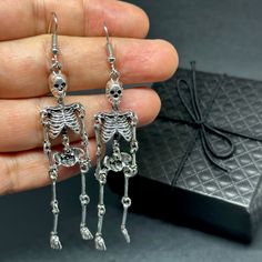 Get ready to dance the night away with these one-sided skeleton earrings in a vintage metallic silver finish! Perfect for any occasion - Halloween, Day of the Dead, a birthday party, or a night out with friends. Lightweight, articulated (all limbs are movable) and beautifully detailed, these earrings make a unique and original gift for yourself or someone special. Add some gothic, punk, and tattoo fashion to your look with these playful and quirky CALACAMANIA™ accessories Earrings details: Size: Tattoo Fashion, Skeleton Earrings, Halloween Day, Dance With You, Gothic Punk, Tattoo Styles, Original Gift, Day Of The Dead, Cute Jewelry