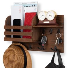 a wooden shelf with keys, wallets and other items on it next to a purse