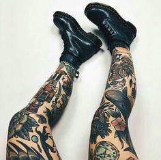 the legs and ankles of a tattooed man with black shoes on them are covered in tattoos