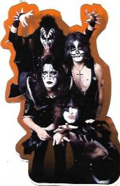 the kiss band is posing for a photo in their black and white costumes with orange accents