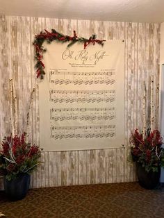 the wall is decorated with sheet music and christmas decorations, along with two large planters