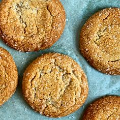 several cookies are arranged on a piece of parchment paper