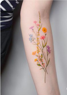 a woman's arm with flowers on it and the words, i love my tattoos