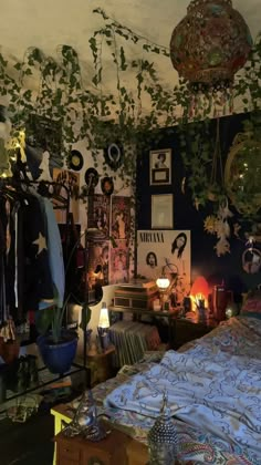 a bedroom with plants growing on the wall and pictures hanging from the ceiling above it