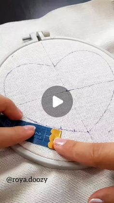 someone is working on a heart - shaped piece of fabric