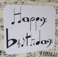 a birthday card with musical notes and the words happy birthday written in black on it