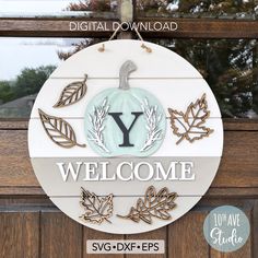 a welcome sign hanging from the side of a wooden door