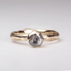 a close up of a gold ring with a diamond