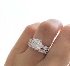 a woman's hand holding an engagement ring