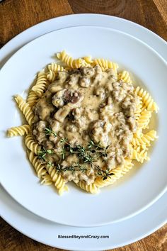 a white plate topped with pasta covered in gravy