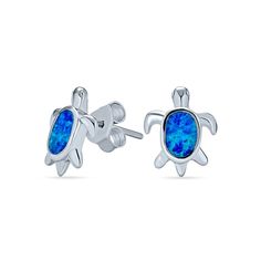 Show off your love for the ocean with these lively blue lab-created opal sea turtle stud earrings in silver. Crafted in sterling silver Each earring features a sea turtle glistening with an oval-shaped iridescent blue lab-created opal cabochon inlay as the shell. These post earrings secure comfortably with wire backs. Opal Birthstone, Iridescent Blue, Nautical Jewelry, Turtle Pendant, Opal Earrings Stud, Opal Studs, Animal Earrings, Earring Studs, Small Earrings Studs