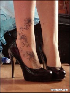 a woman's legs with tattoos on them