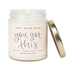 you got this scented candle in a glass jar with a gold lid and the words sweet water decor on it