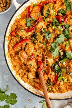 a pan filled with rice and vegetables on top of a table