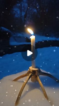 a candle that is sitting in the snow