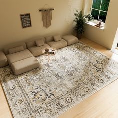 a living room with a large rug on the floor and a couch next to it