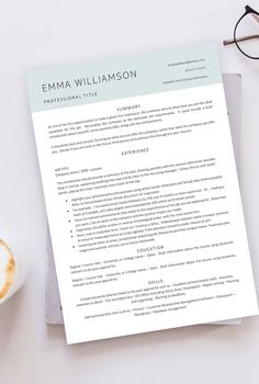 a professional resume is displayed on top of a desk next to a cup of coffee