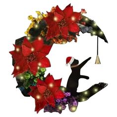 a christmas wreath with poinsettis and lights on the top is decorated with a cat holding an umbrella