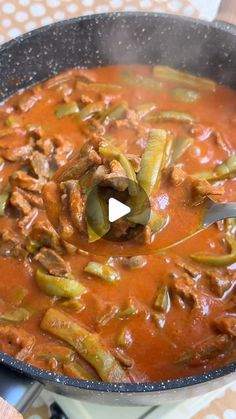 a pot filled with meat and vegetables on top of a stove