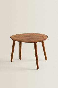 a small wooden table with two legs and a round top, on a white background