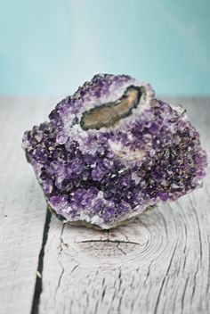 a purple rock sitting on top of a wooden table