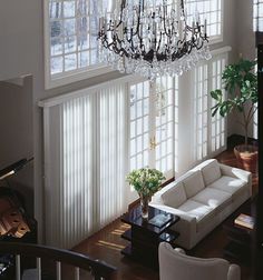 a living room filled with furniture and a chandelier