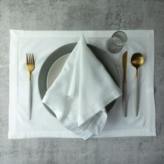 a place setting with silverware and napkins