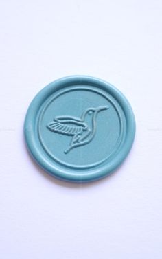 a blue wax stamp with a bird on it