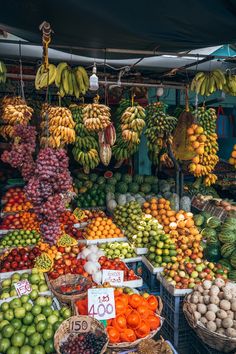 an outdoor market with lots of fruits and vegetables