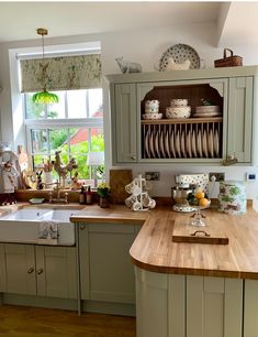 a kitchen filled with lots of counter top space and wooden counters next to a window