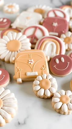 decorated cookies are arranged on a table with white and pink icing in the shape of flowers