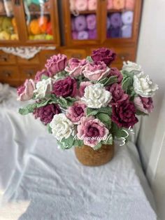 a vase filled with lots of pink and white flowers