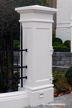 a white toilet sitting next to a black fence