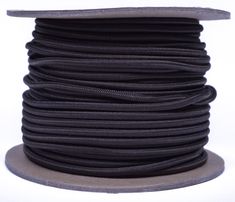 a spool of black round cord on a white background