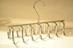 a metal hanger with five hooks on it