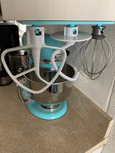 a blue mixer sitting on top of a kitchen counter