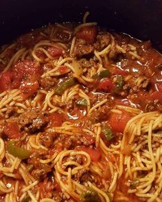 a pot filled with spaghetti and meat in sauce