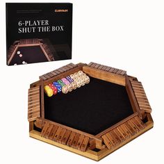 a wooden board game set with dices and cards in front of the card box