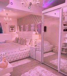 a bedroom with mirrored walls and white furniture